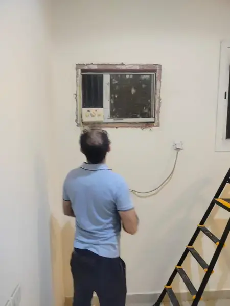 Window AC unit installation in progress
